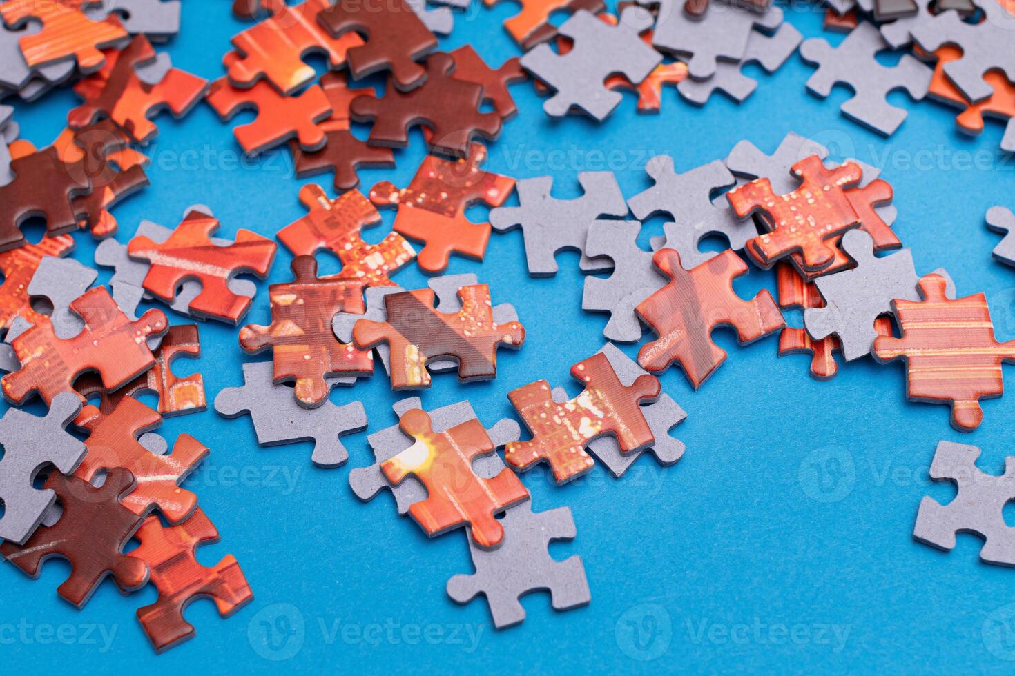Mixed Pieces of a Colorful Jigsaw Puzzle Lie on the Blue Background - Strategy and Solving Problem Concept photo