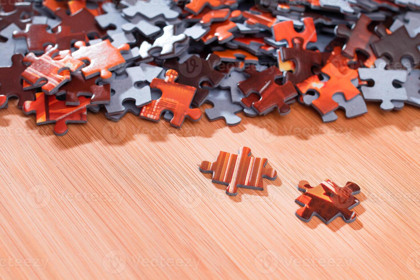 Colorful Pieces of a Mixed Jigsaw Puzzle Lie on the Wooden Table - Strategy and Solving Problem Concept photo