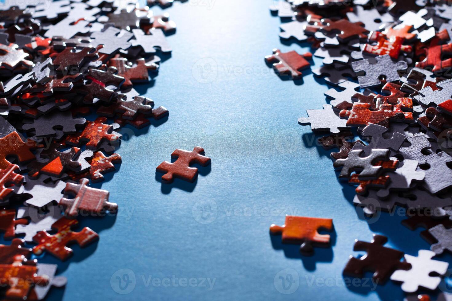 Mixed Pieces of a Colorful Jigsaw Puzzle Lie on the Blue Background - Strategy and Solving Problem Concept photo