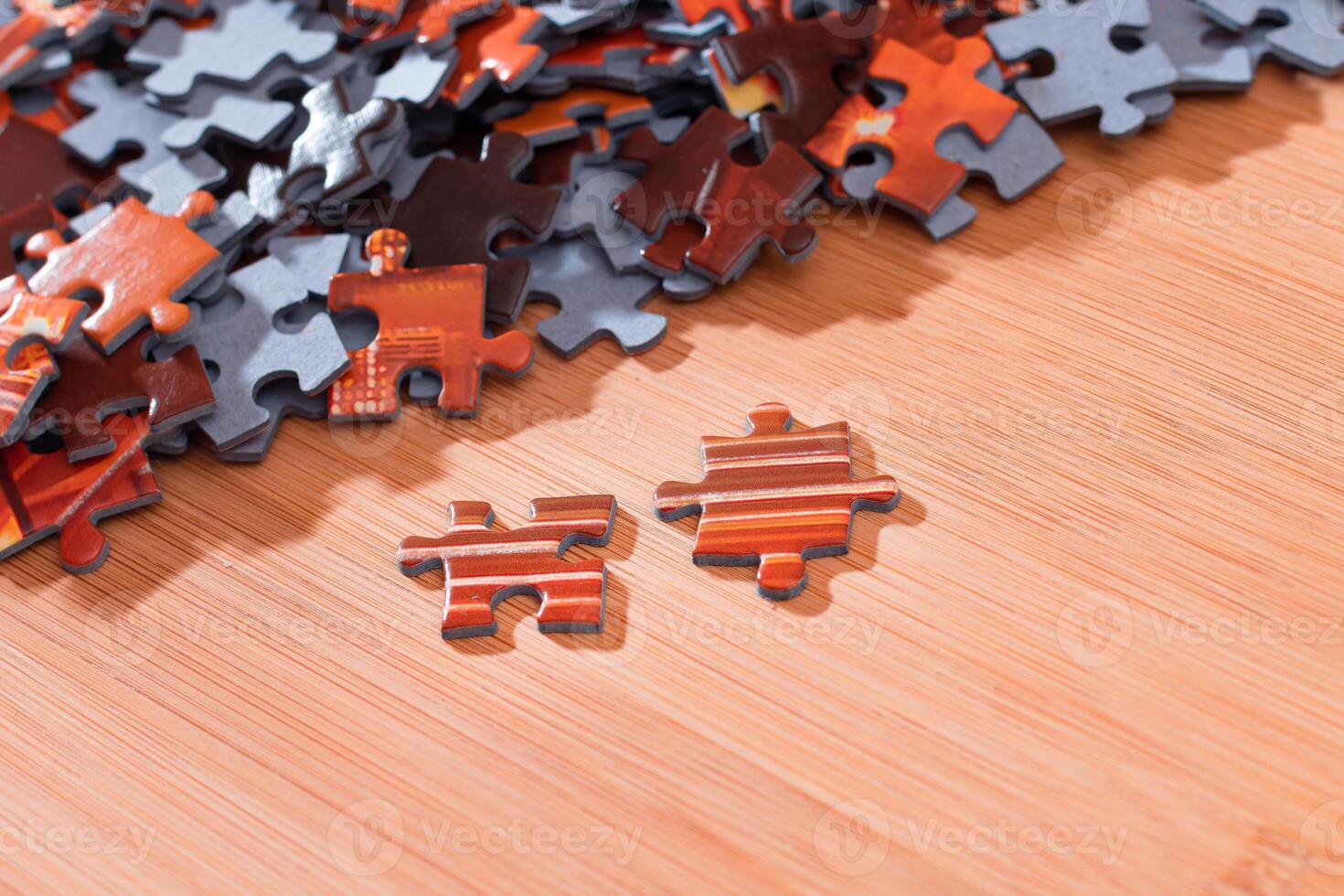 Colorful Pieces of a Mixed Jigsaw Puzzle Lie on the Wooden Table - Strategy and Solving Problem Concept photo