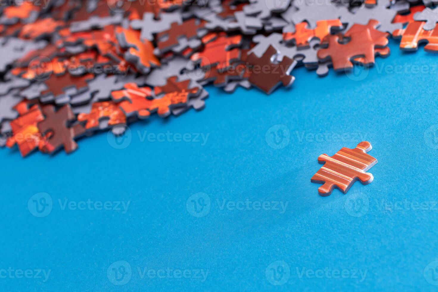 Mixed Pieces of a Colorful Jigsaw Puzzle Lie on the Blue Background - Strategy and Solving Problem Concept photo