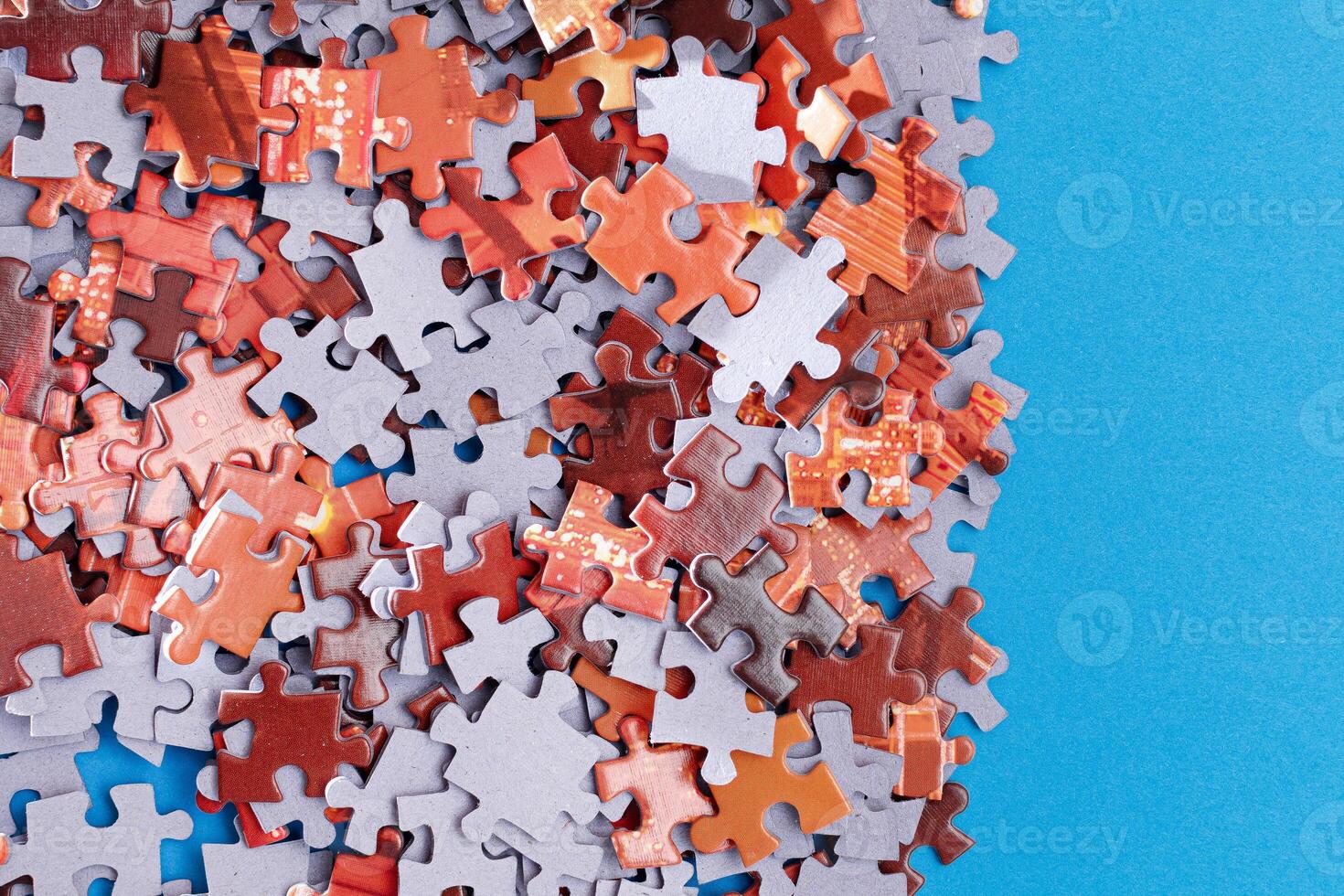 Mixed Pieces of a Colorful Jigsaw Puzzle Lie on the Blue Background - Strategy and Solving Problem Concept photo
