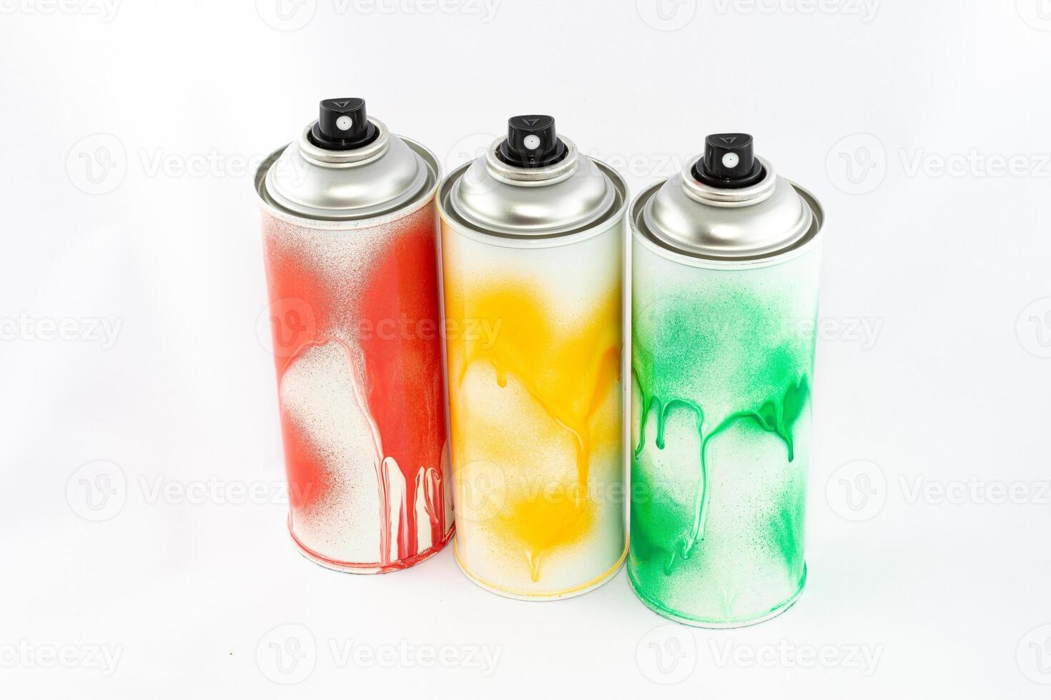 Three Colored Spray Paint Cans on White Background. Graffiti's Inventory - Close-Up Shot photo