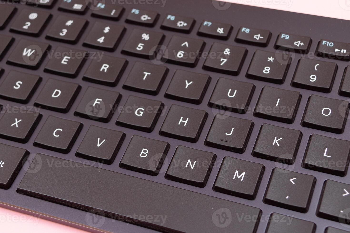 Black Bluetooth Keyboard for Tablet or PC on Pink Background photo