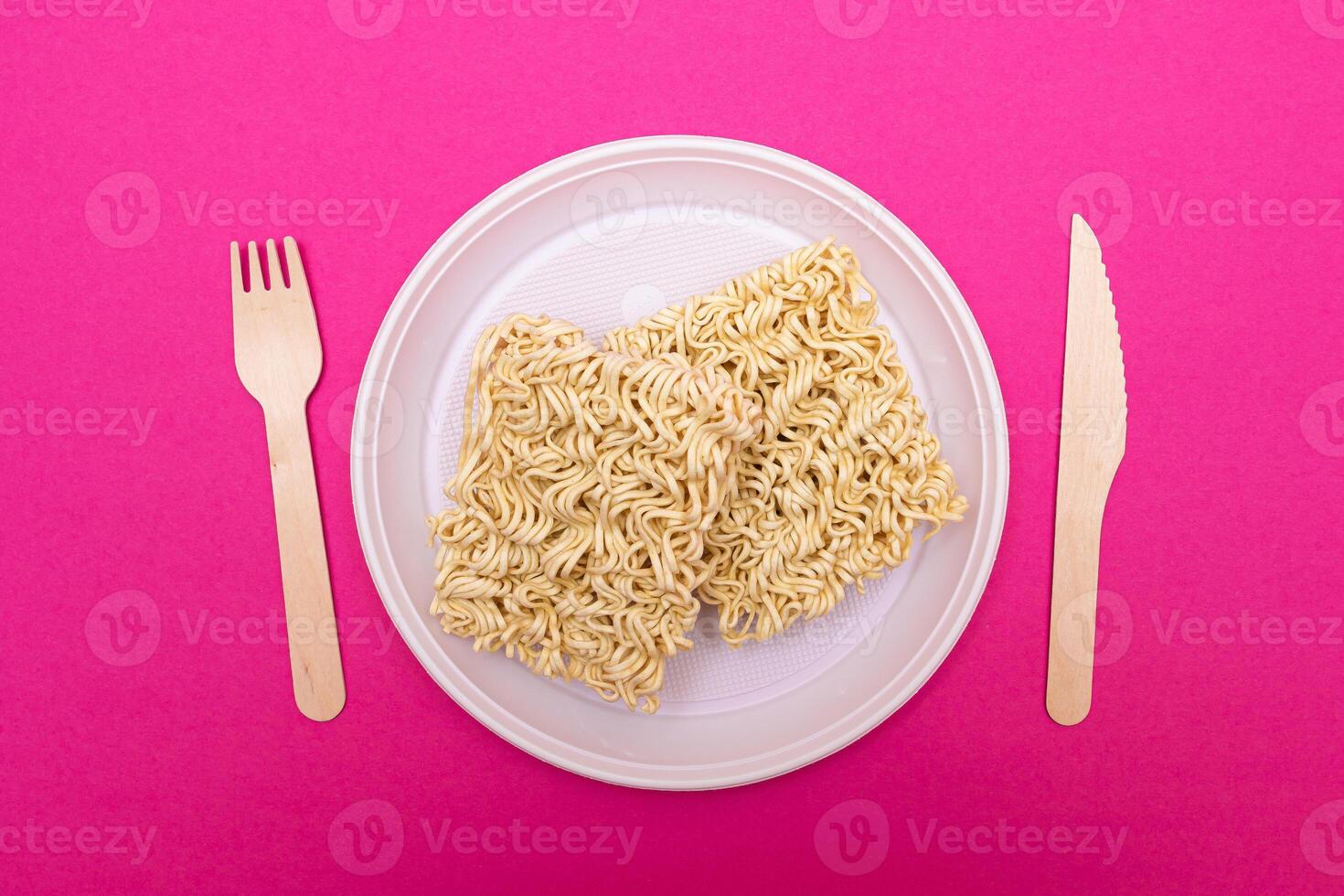 Uncooked Instant Noodles on White Plate. Raw Pasta. Dry Asian Fast Food. Quick Lunch photo