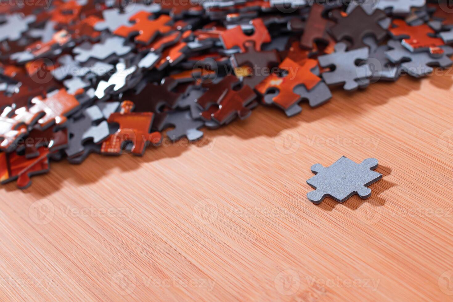 Colorful Pieces of a Mixed Jigsaw Puzzle Lie on the Wooden Table - Strategy and Solving Problem Concept photo