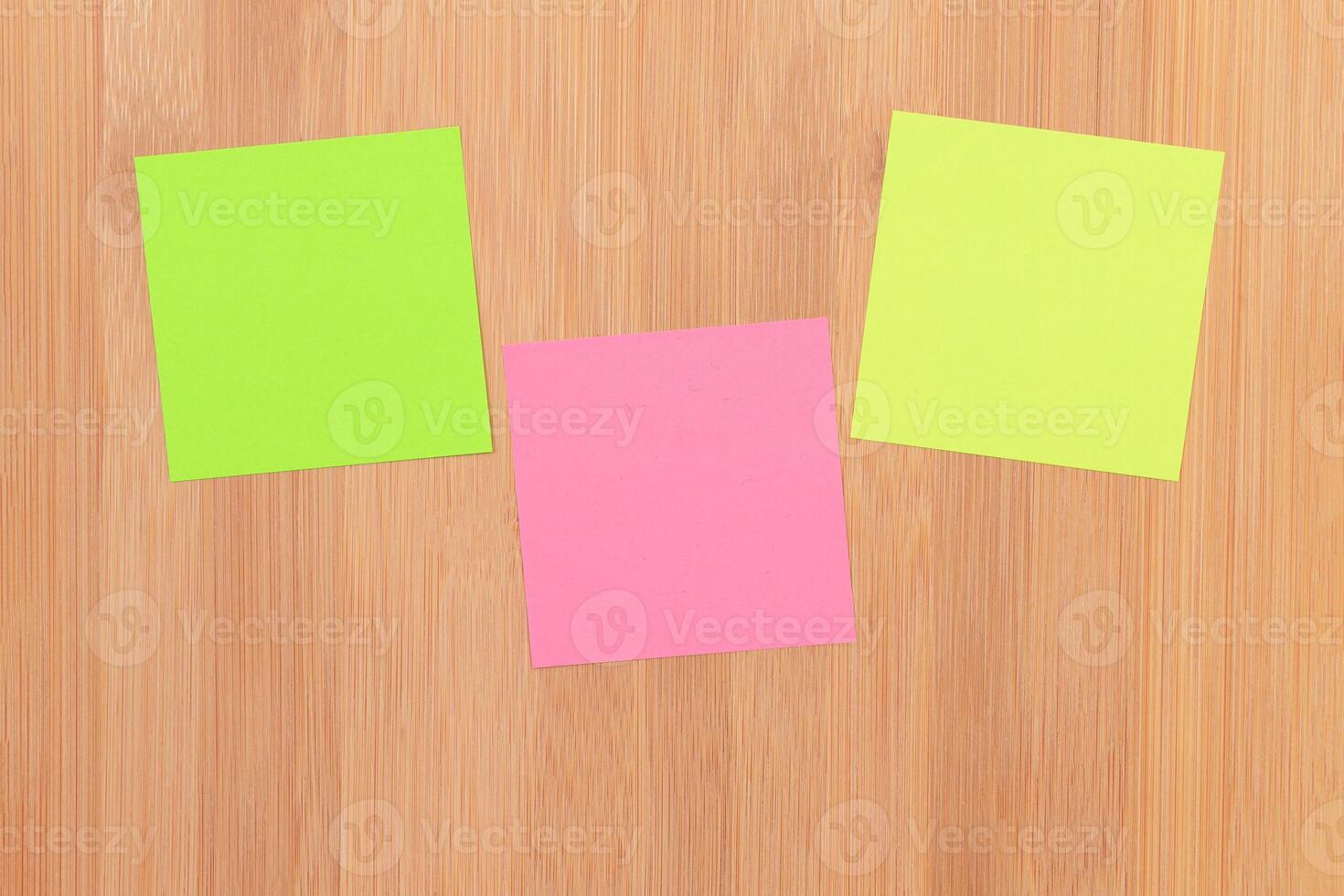 Colored Sticky Notes with Copyspace Pinned to the Wooden Message Board. To Do List Reminder in Office. Blank Memo Sticker at Work - Template. Empty Checklist - Mockup photo