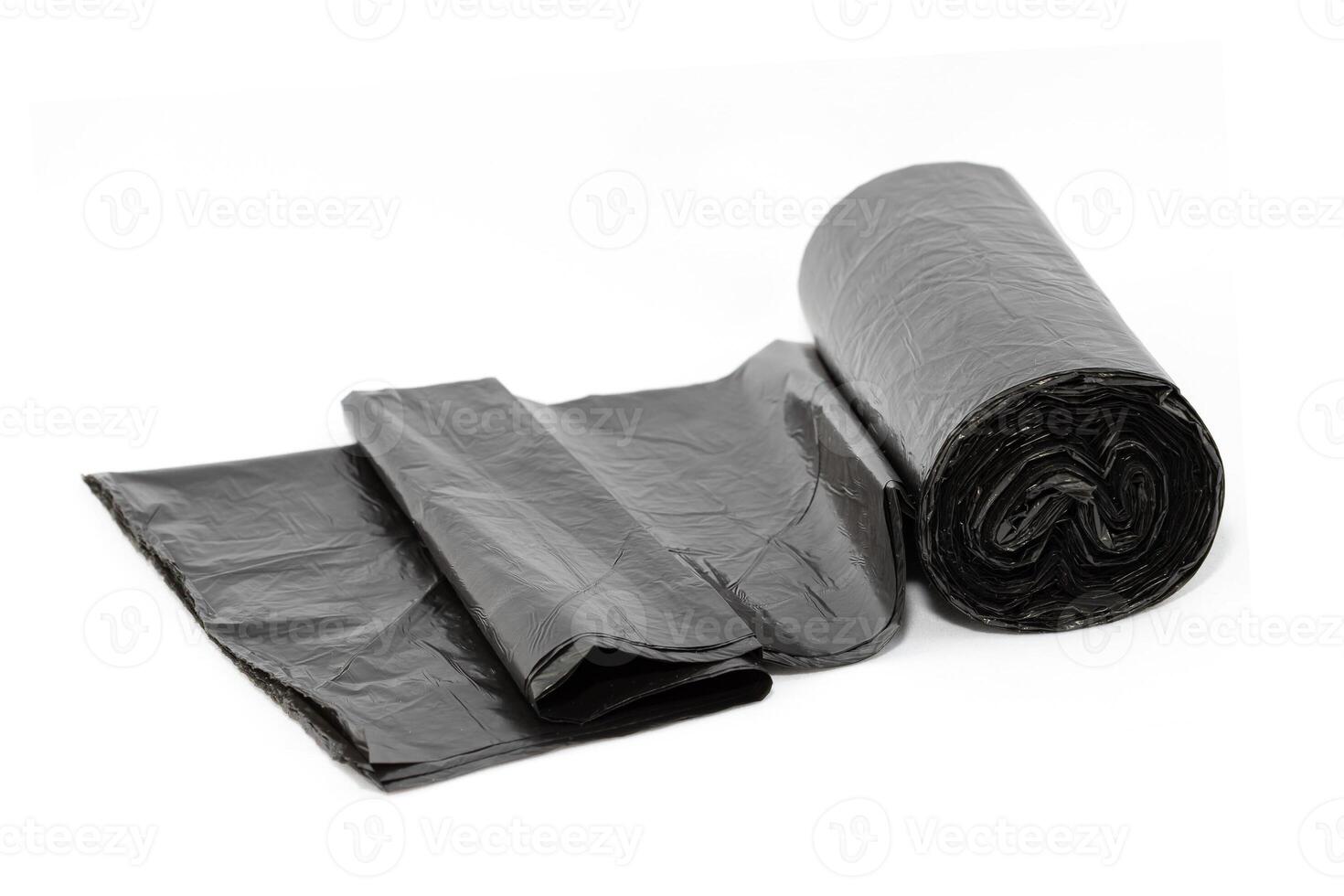 Black Polyethylene Garbage Bags on White Background - Close-Up. The Roll of Plastic Junk Package photo