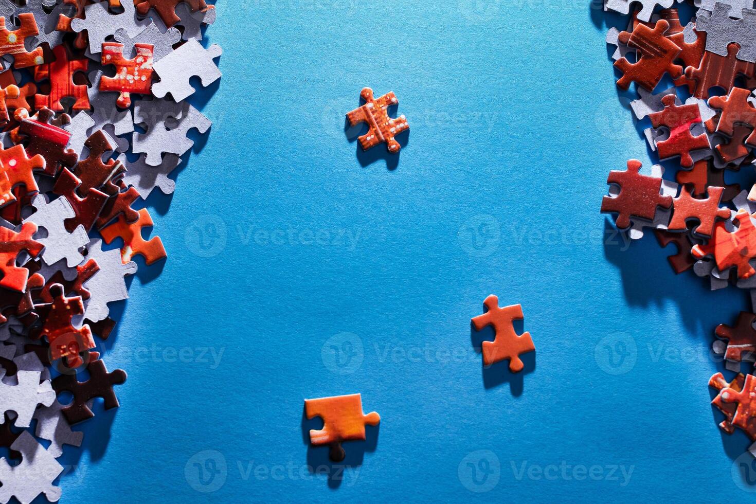 Mixed Pieces of a Colorful Jigsaw Puzzle Lie on the Blue Background - Strategy and Solving Problem Concept photo