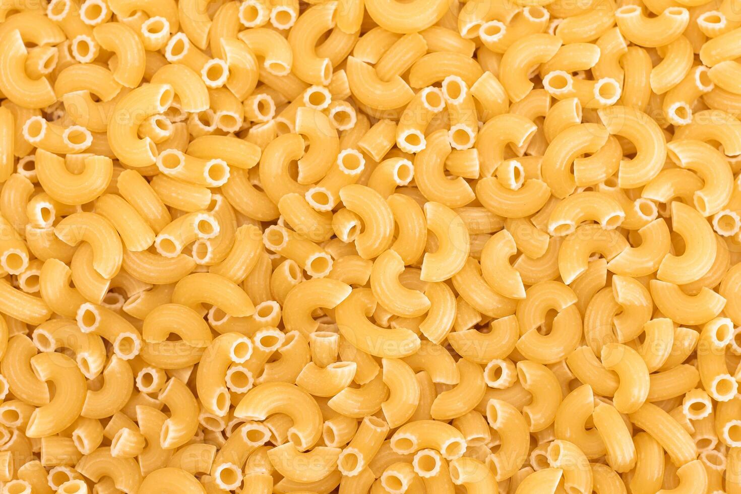 Uncooked Chifferi Rigati Pasta Background. Fat and Unhealthy Food. Classic Dry Macaroni Texture. Italian Culture and Cuisine. Raw Pasta photo