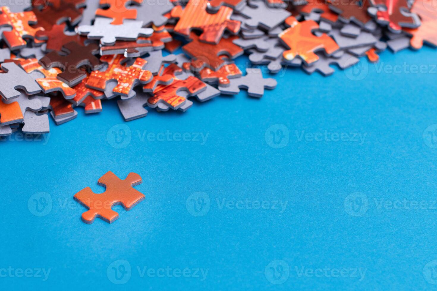 Mixed Pieces of a Colorful Jigsaw Puzzle Lie on the Blue Background With Copy Space - Strategy and Solving Problem Concept photo