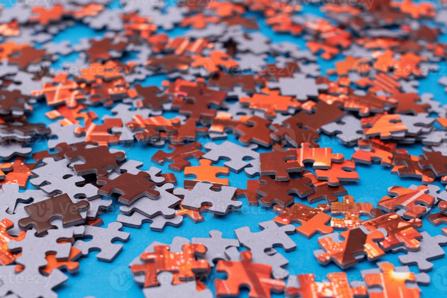 Mixed Pieces of a Colorful Jigsaw Puzzle Lie on the Blue Background - Strategy and Solving Problem Concept photo