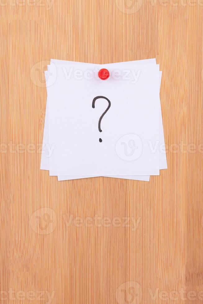 White Sticky Notes with Question Mark Pinned to the Wooden Message Board. To Do List Reminder in the Office. Memo Note at Work photo
