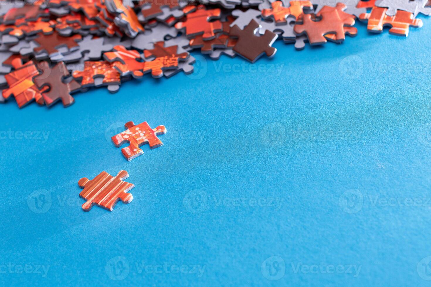 Mixed Pieces of a Colorful Jigsaw Puzzle Lie on the Blue Background - Strategy and Solving Problem Concept photo