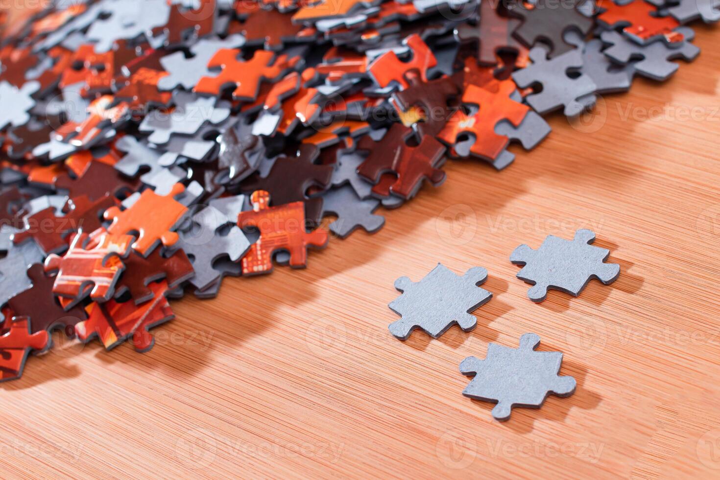 Colorful Pieces of a Mixed Jigsaw Puzzle Lie on the Wooden Table - Strategy and Solving Problem Concept photo