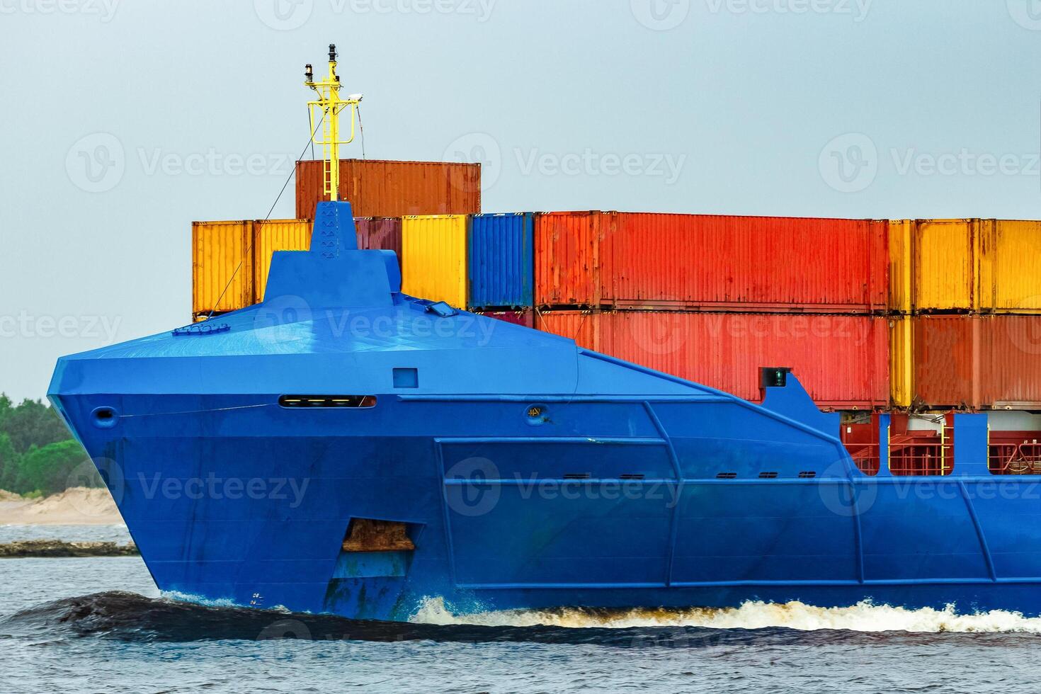 Blue cargo container ship fully loaded underway photo