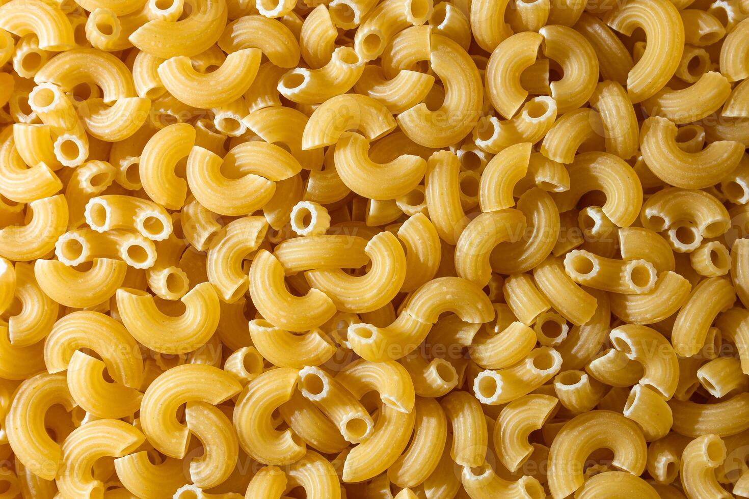 Uncooked Chifferi Rigati Pasta. A Culinary Canvas of Chifferi Rigati, Creating a Lively and Textured Background for Gourmet Cooking. Dry Pasta. Raw Macaroni - Top View, Flat Lay photo