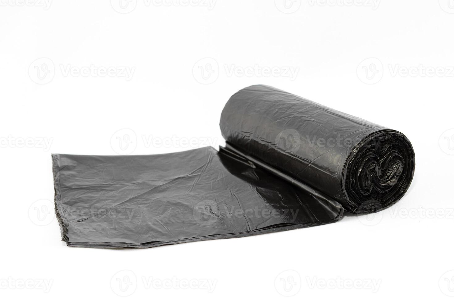 Black Polyethylene Garbage Bags on White Background - Close-Up. The Roll of Plastic Junk Package photo