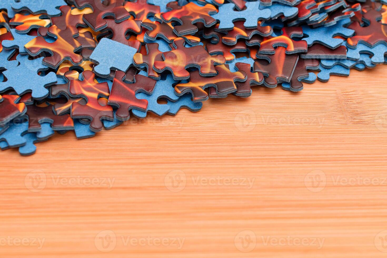 Colorful Pieces of a Mixed Jigsaw Puzzle Lie on the Wooden Table - Strategy and Solving Problem Concept photo