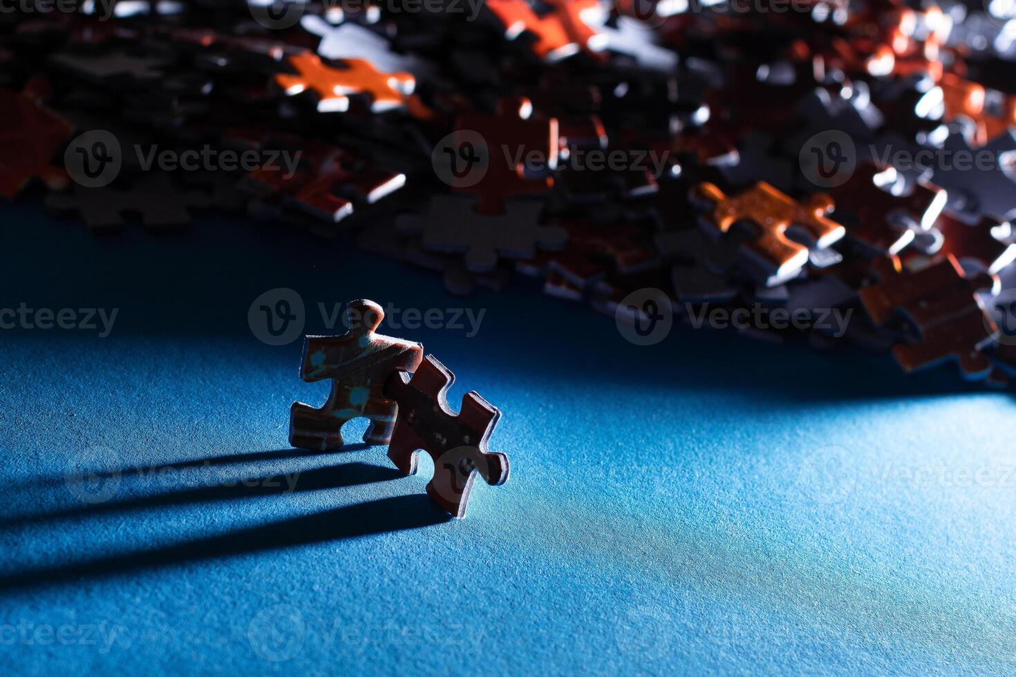Mixed Pieces of a Colorful Jigsaw Puzzle Lie on the Blue Background - Strategy and Solving Problem Concept photo