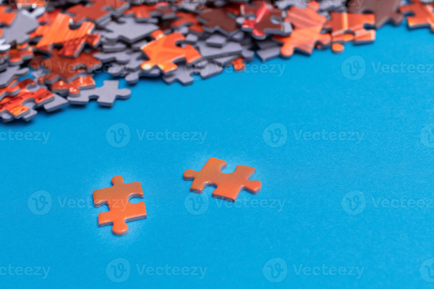 Mixed Pieces of a Colorful Jigsaw Puzzle Lie on the Blue Background - Strategy and Solving Problem Concept photo