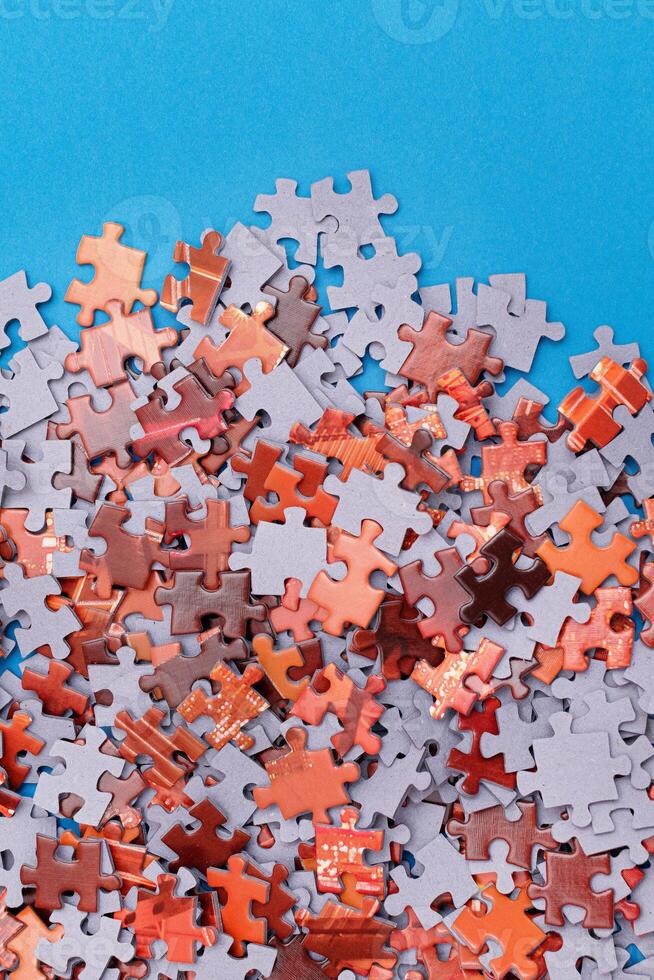 Mixed Pieces of a Colorful Jigsaw Puzzle Lie on the Blue Background - Strategy and Solving Problem Concept photo