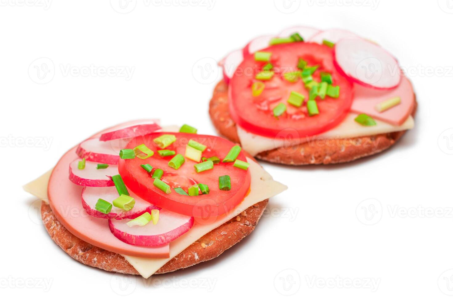 Crispy Cracker Sandwiches with Tomato, Sausage, Cheese, Green Onions and Radish - Isolated on White. Easy Breakfast. Diet Food. Quick and Healthy Sandwiches. Crispbread with Tasty Filling - Isolation photo