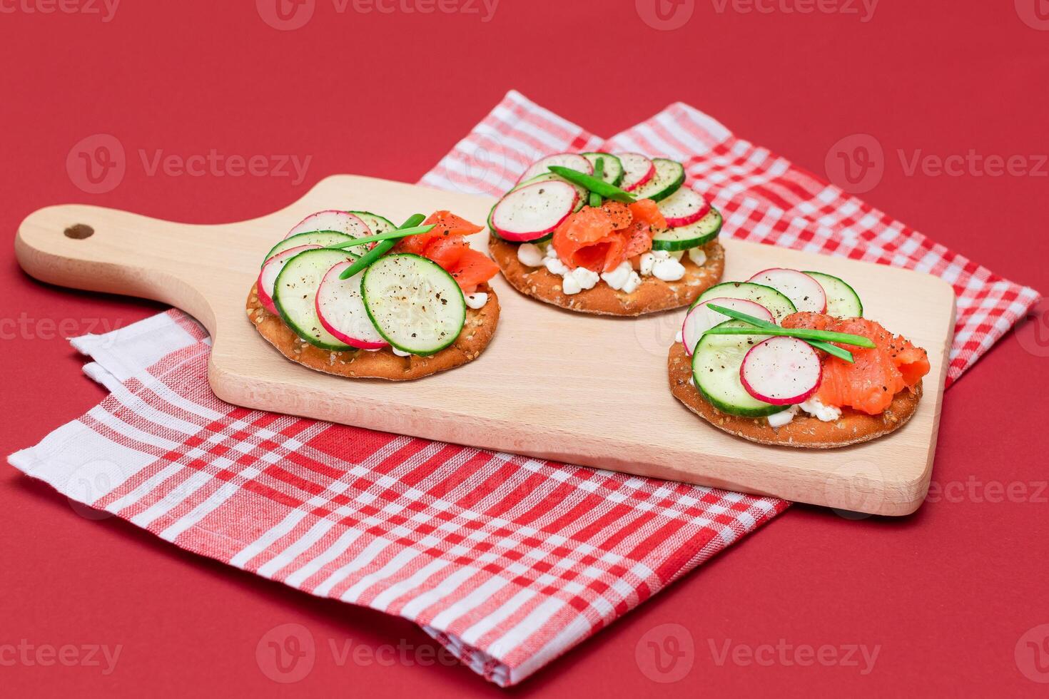 Crispy Cracker Sandwiches with Fresh Salmon, Cucumber, Radish, Cottage Cheese and Green Onions. Easy Breakfast. Quick and Healthy Sandwiches. Crispbread with Tasty Filling. Healthy Dietary Snack photo
