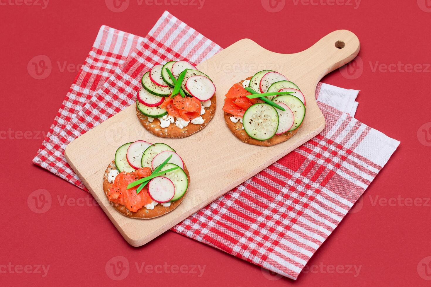 Crispy Cracker Sandwiches with Fresh Salmon, Cucumber, Radish, Cottage Cheese and Green Onions. Easy Breakfast. Quick and Healthy Sandwiches. Crispbread with Tasty Filling. Healthy Dietary Snack photo