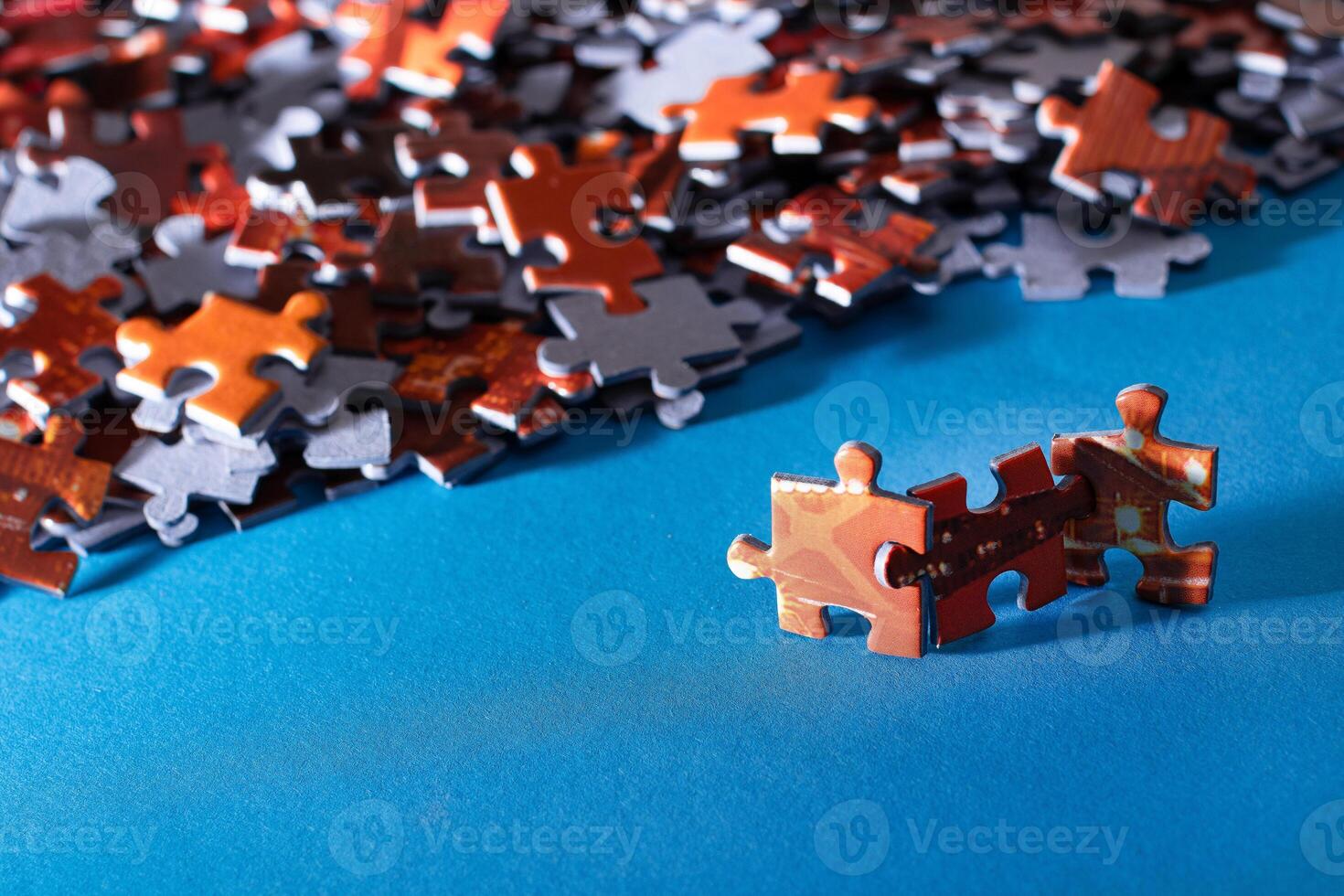 Mixed Pieces of a Colorful Jigsaw Puzzle Lie on the Blue Background - Strategy and Solving Problem Concept photo