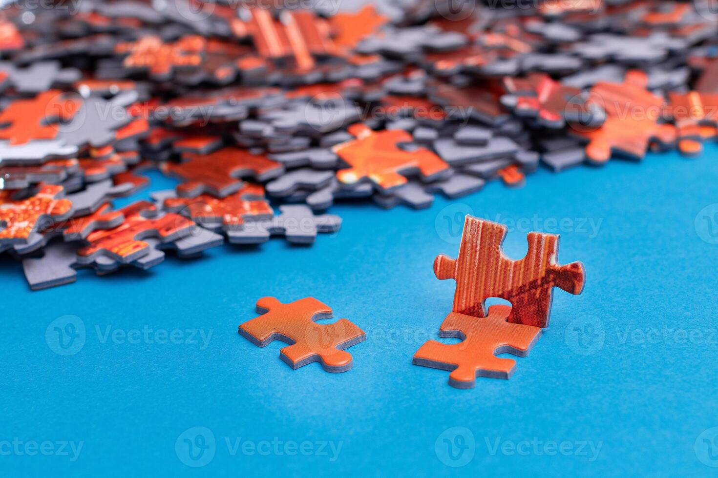 Mixed Pieces of a Colorful Jigsaw Puzzle Lie on the Blue Background - Strategy and Solving Problem Concept photo