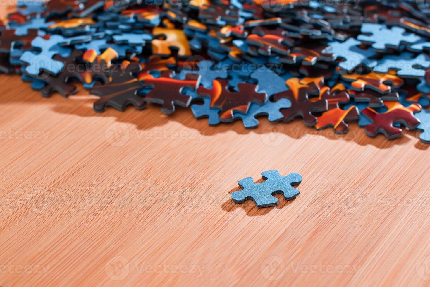 Colorful Pieces of a Mixed Jigsaw Puzzle Lie on the Wooden Table - Strategy and Solving Problem Concept photo