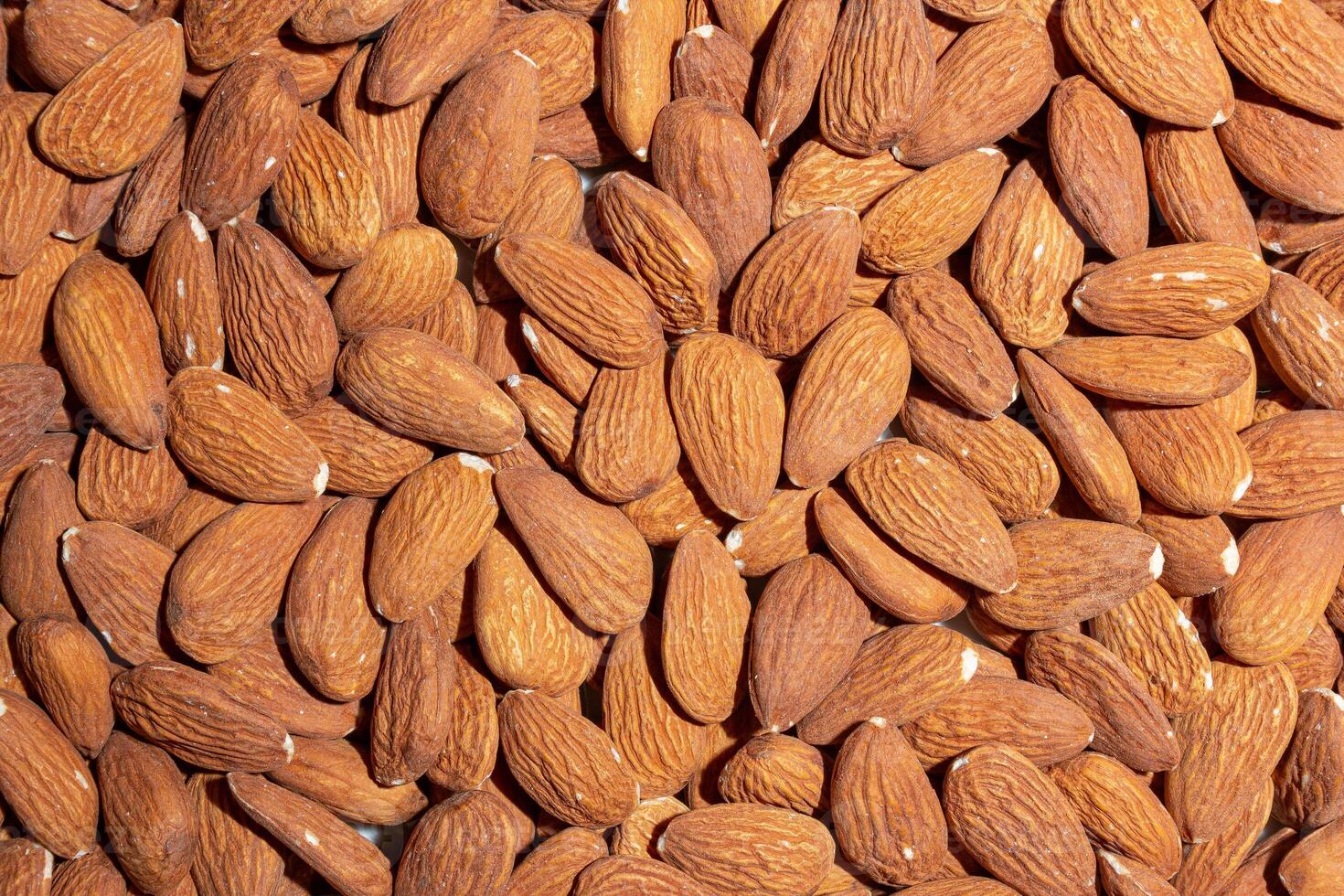 Scattered Almonds. Background from Almond Nuts. Natural High-Calorie Snacks photo