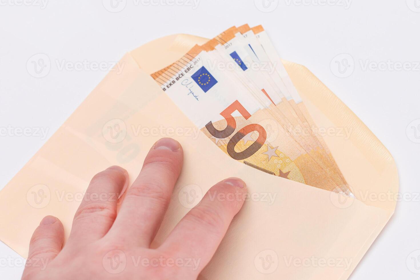 Hand Holds An Orange Paper Envelope with Stack of 50-Euro Banknotes Inside. Salary in Cash. Tax-Free System. Euro Currency. Payments with No Taxes. Orange Paper Money. A Lot of Fifty-Euro Bills photo
