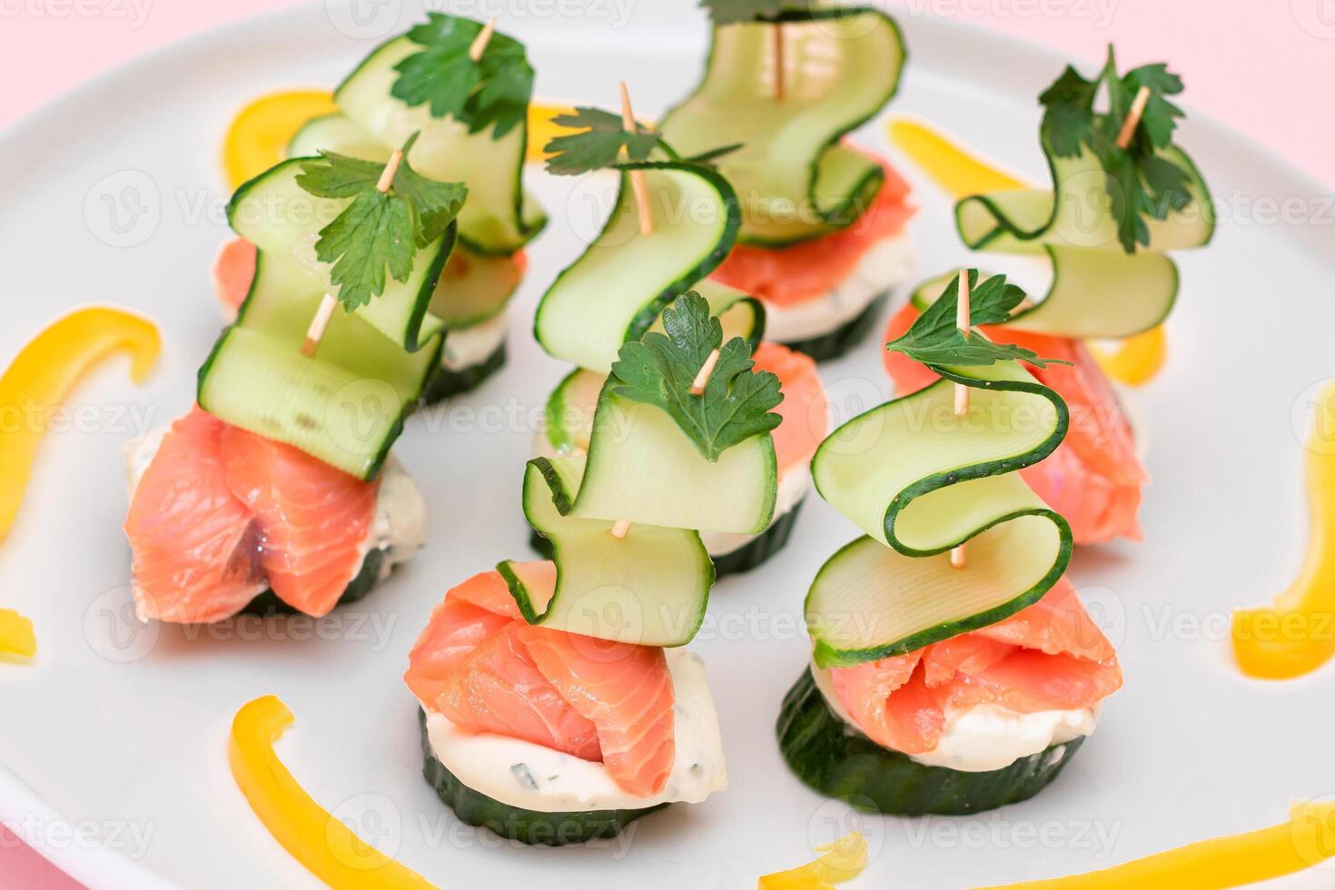 Canapes without Bread with Fresh Salmon, Cucumber and Cream Cheese on White Plate. Easy Breakfast. Diet Food. Quick and Healthy Sandwiches. Healthy Snacks with Tasty Fillings photo