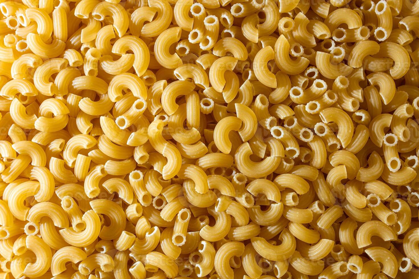 Uncooked Chifferi Rigati Pasta. A Culinary Canvas of Chifferi Rigati, Creating a Lively and Textured Background for Gourmet Cooking. Dry Pasta. Raw Macaroni - Top View, Flat Lay photo
