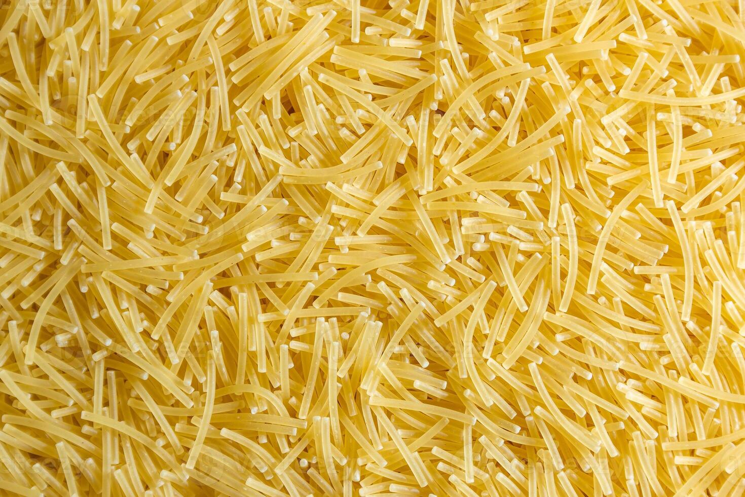 Uncooked Filini Pasta. A Culinary Canvas of Noodles, Creating a Lively and Textured Background for Gourmet Cooking. Dry Pasta. Raw Macaroni - Top View, Flat Lay photo