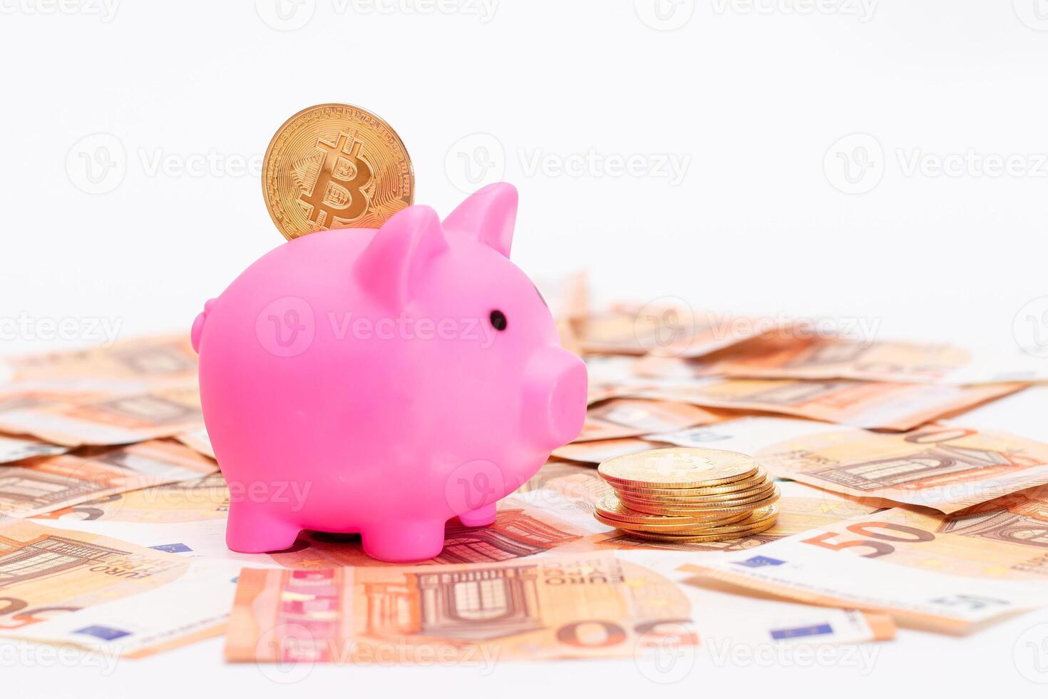 Pink Piggy Bank with Bitcoin Coin on the Fifty Euro Banknotes. Small Money Box for Cash and Coins. Money Saving Concept photo