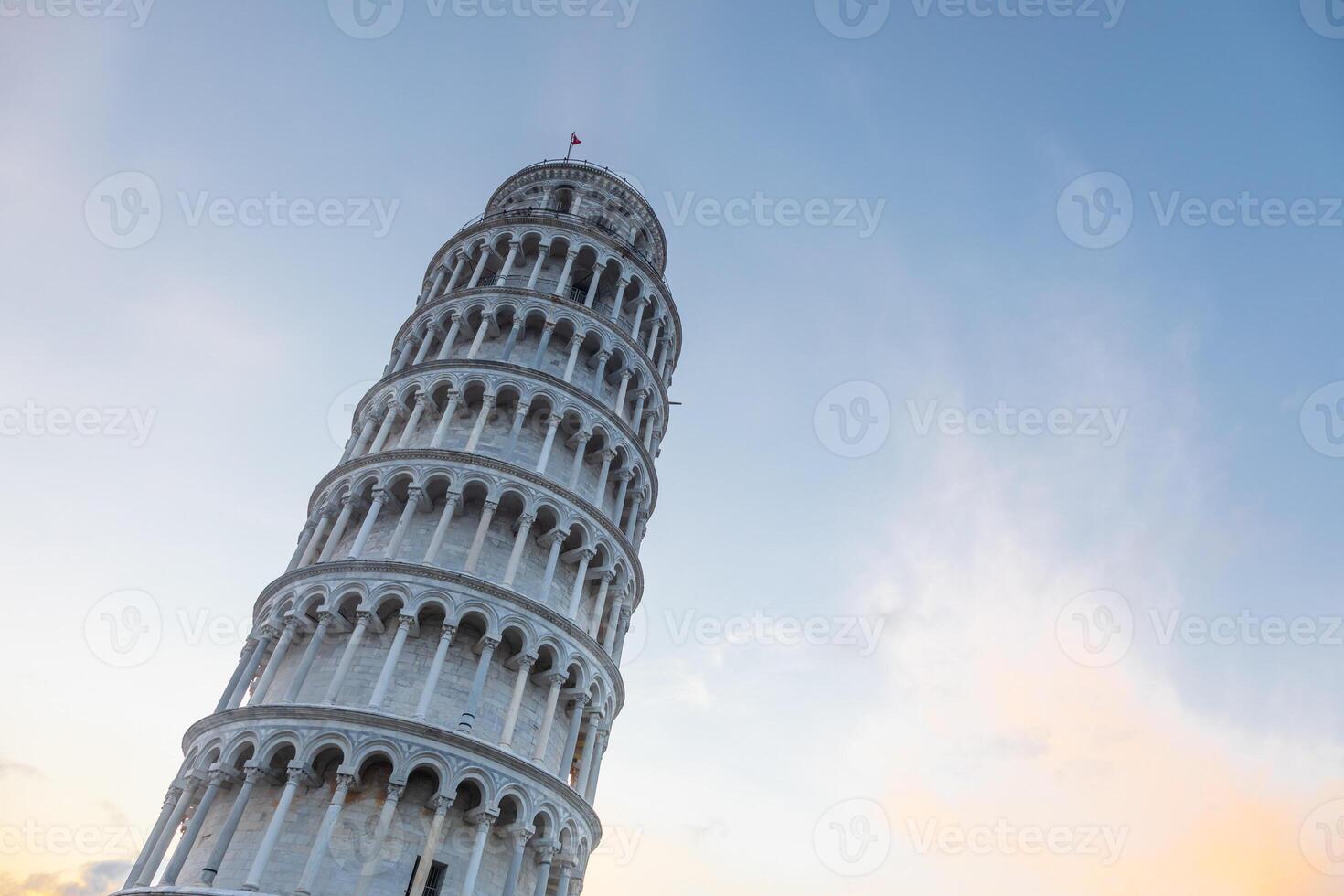 Pisa, Italy. Leaning tower sightseeing with blue sky background. Italian travel destination. photo