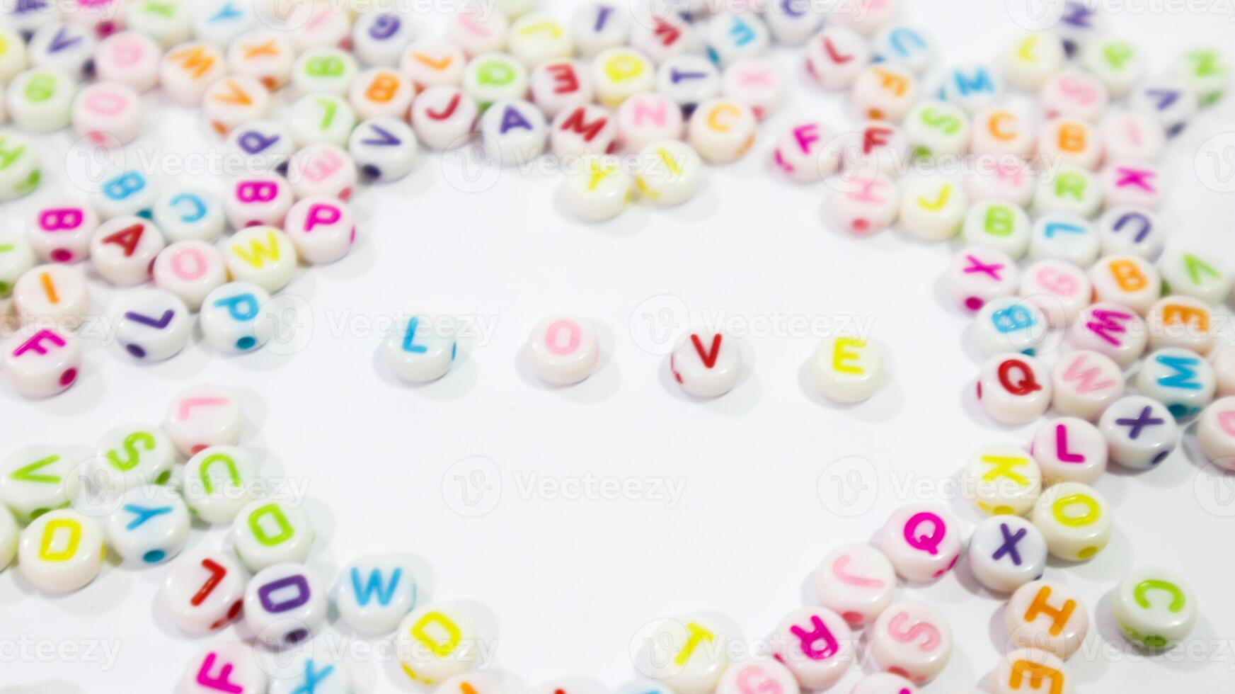 Collection of colourful beads blocks to make handmade jewellery bracelet names, in Rajasthan, India. heap of multi colored beads in an Indian street shop. Alphabets in kinder garden school for kids. photo