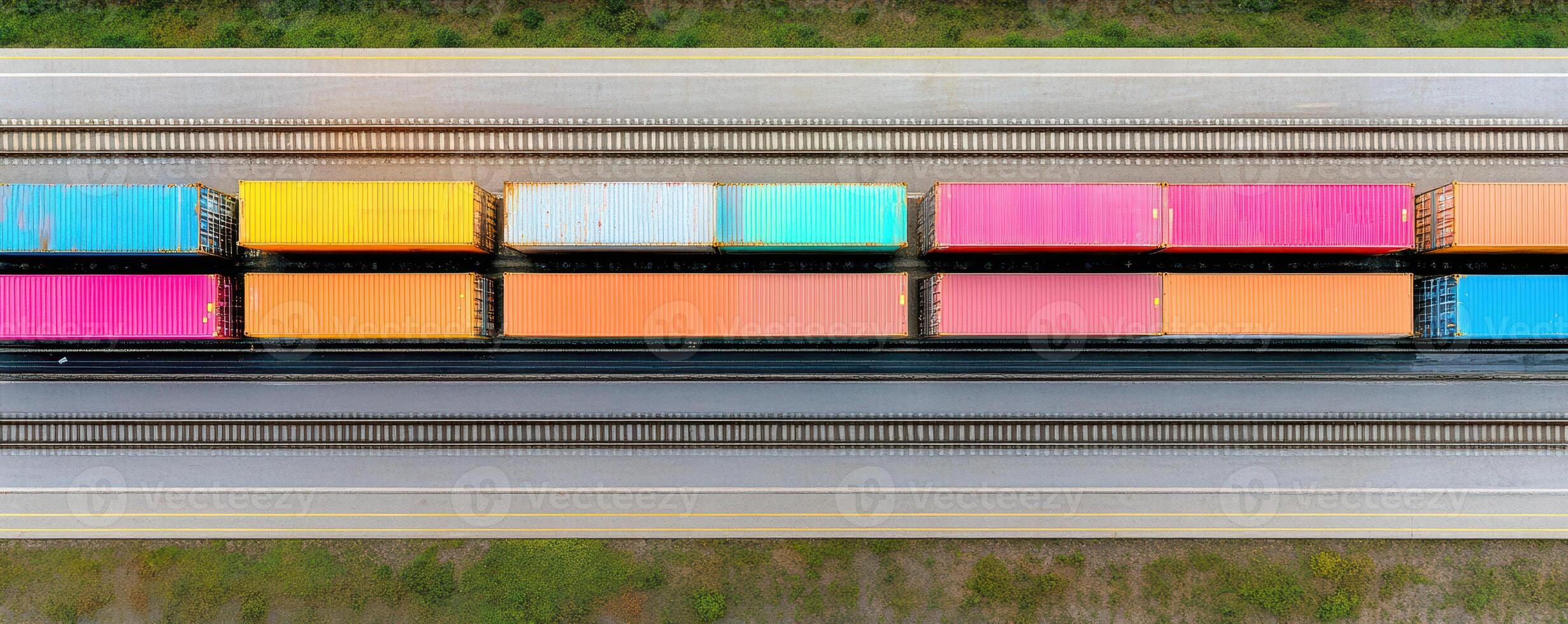 Colorful train containers are lined up along railway, showcasing vibrant array of hues including pink, orange, and blue. This striking visual captures essence of transportation and logistics photo