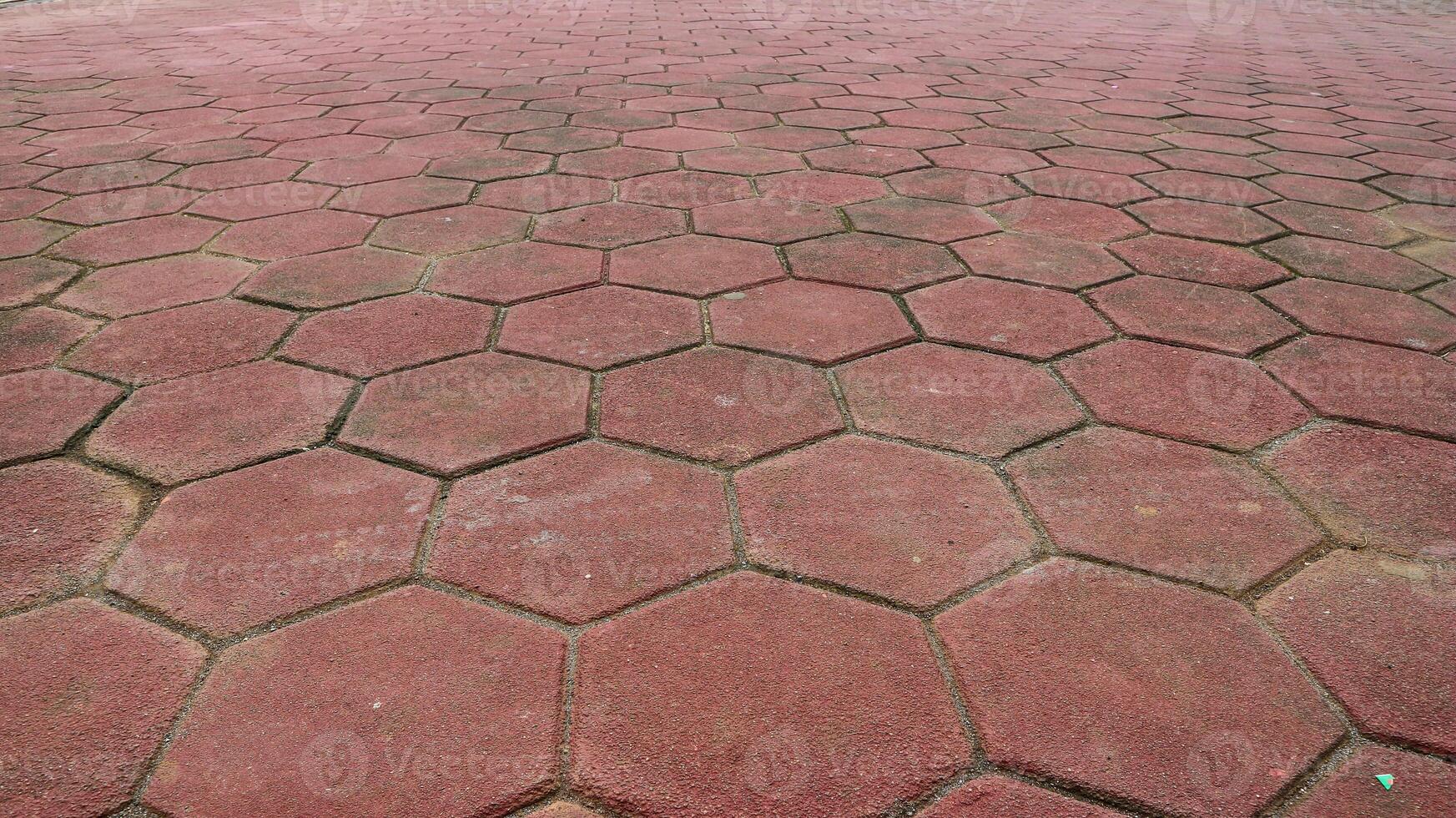 Footpath concrete block. hexagon red paving blocks. The texture of the paved tile on the bottom of the street. Cement brick squared stone floor background. Concrete paving slabs. Paving slabs. photo