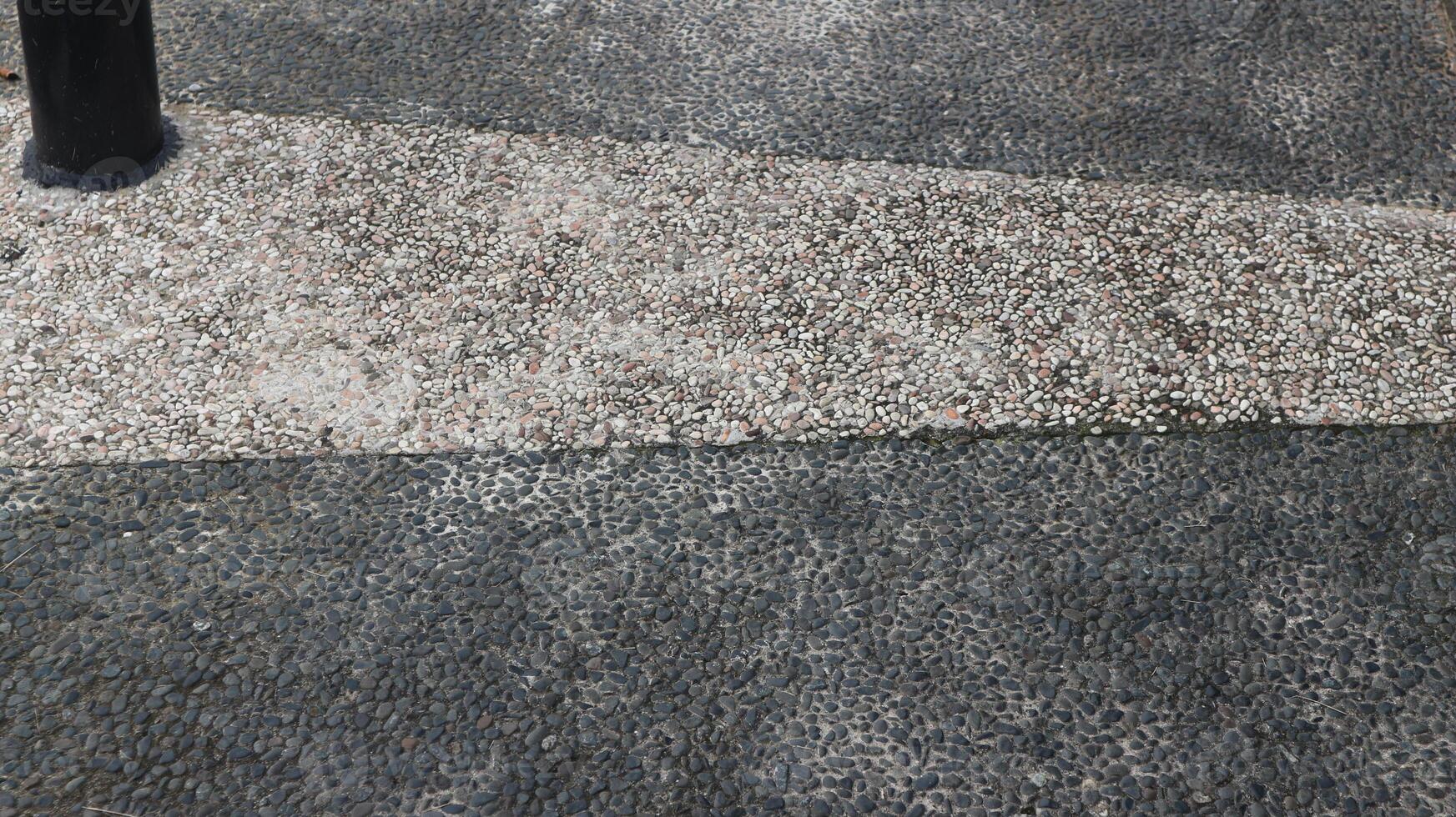 Exposed aggregate concrete with different colored pebbles. Gravel floor in city park. photo