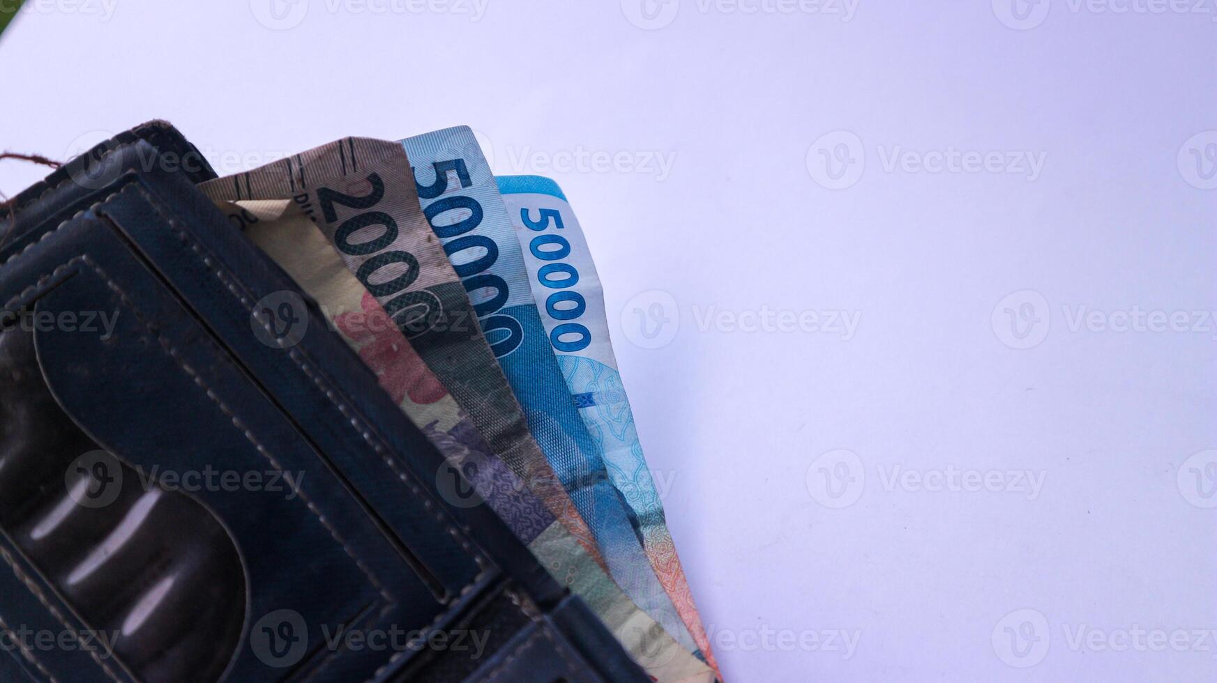 Indonesian paper money Rupiah in a wallet on a white background. photo
