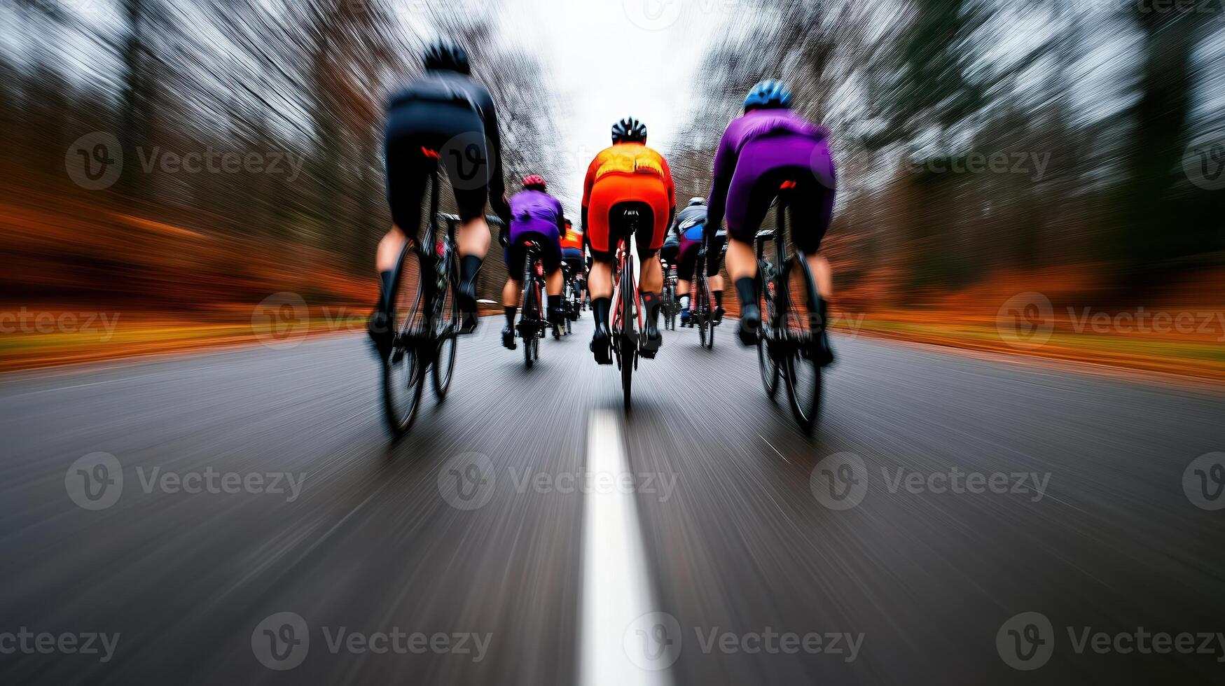dynamic group of cyclists riding on blurred road, showcasing motion and speed in vibrant autumn setting. colorful jerseys add energy to scene photo