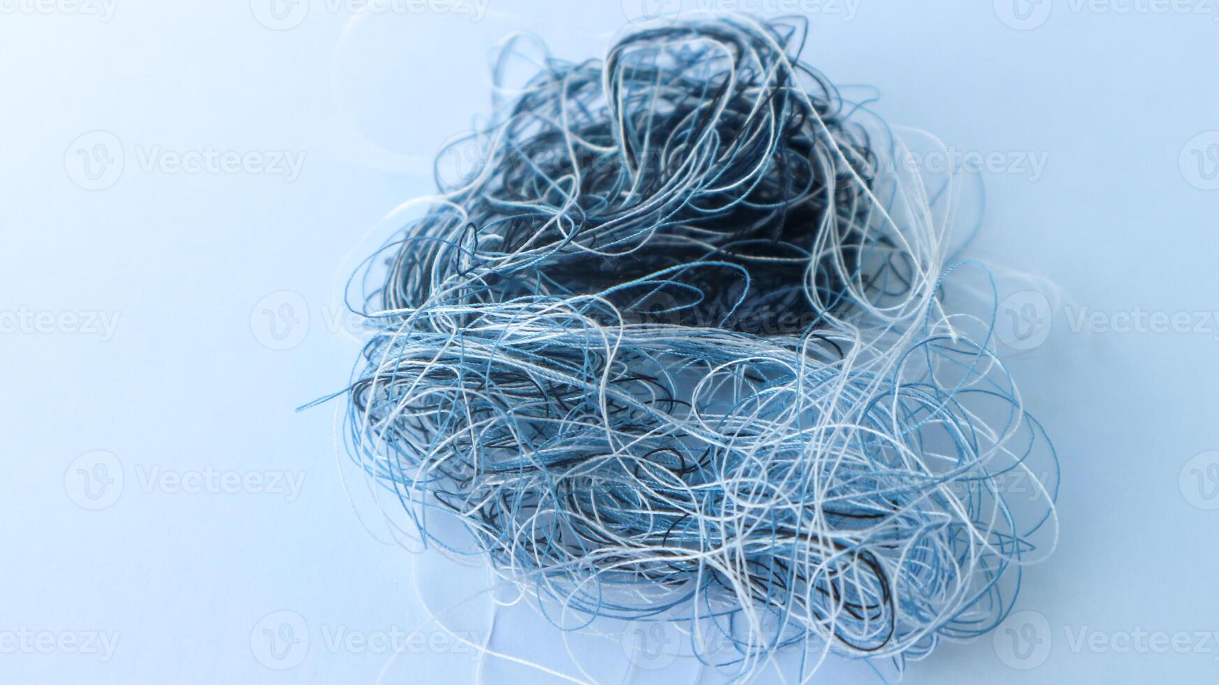 Multi colored tangled threads abstract texture pattern background. Macro shot of colorful needlecraft silk thread ropes. Colored natural thread pile for sewing clothe scattered randomly like spaghetti photo
