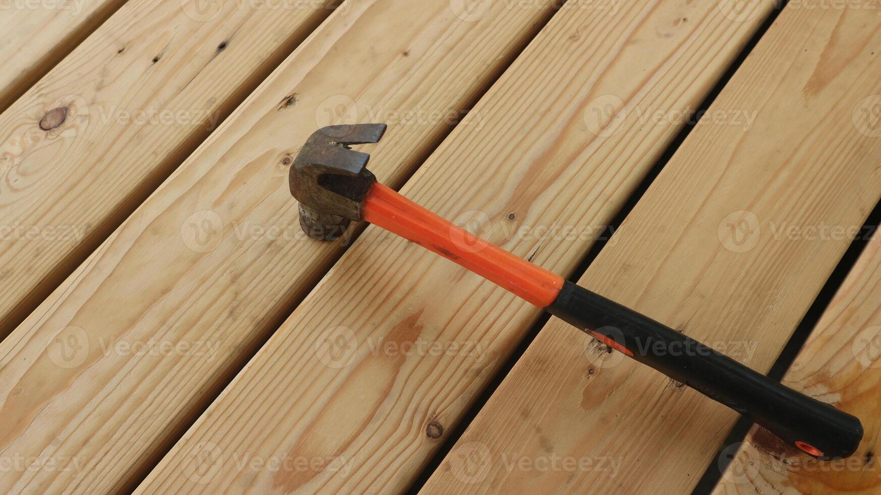 Home construction background. Hammer on wooden table flat lay. photo