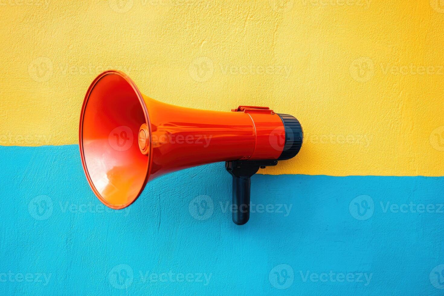 A red megaphone mounted on a yellow and blue wall photo