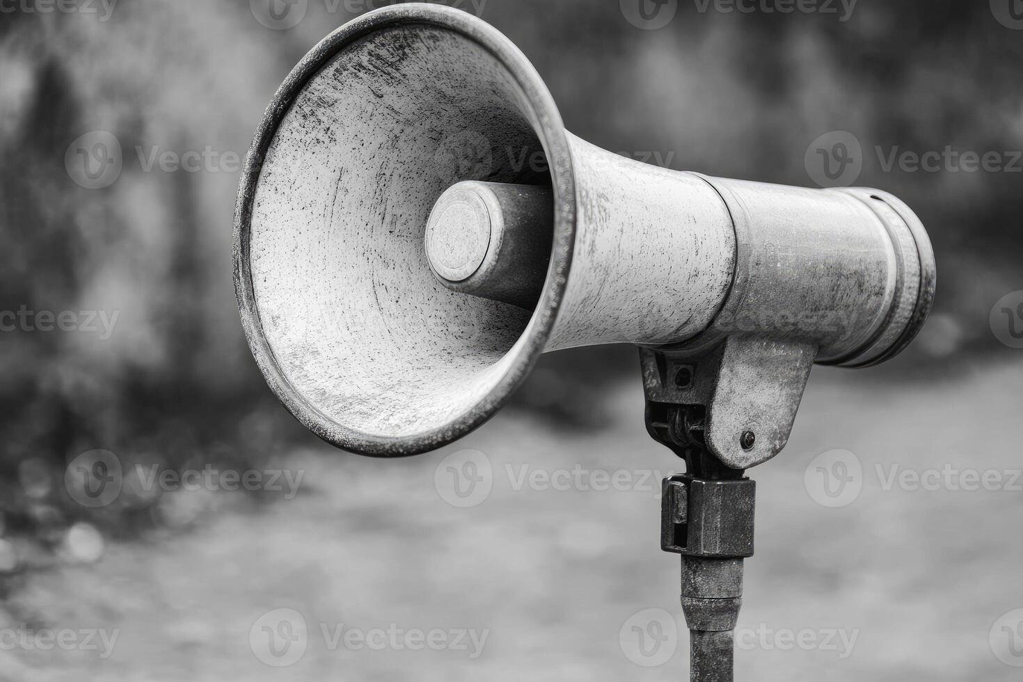 A Worn Vintage Megaphone Mounted on a Stand photo
