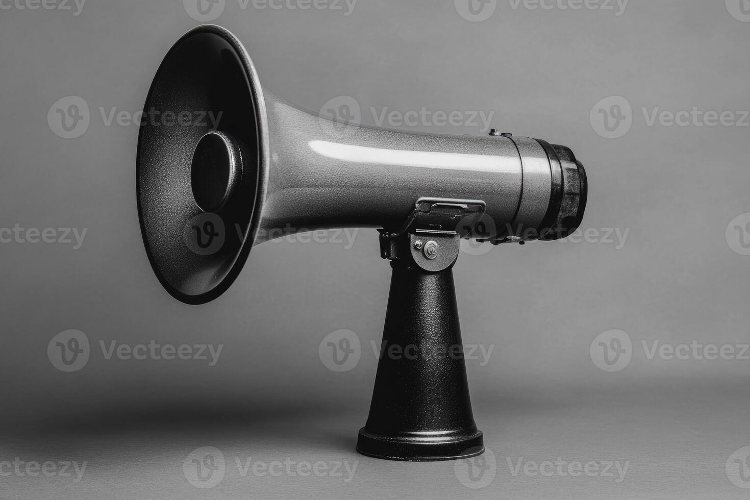 A Grey Megaphone with a Black Base on a Grey Background photo